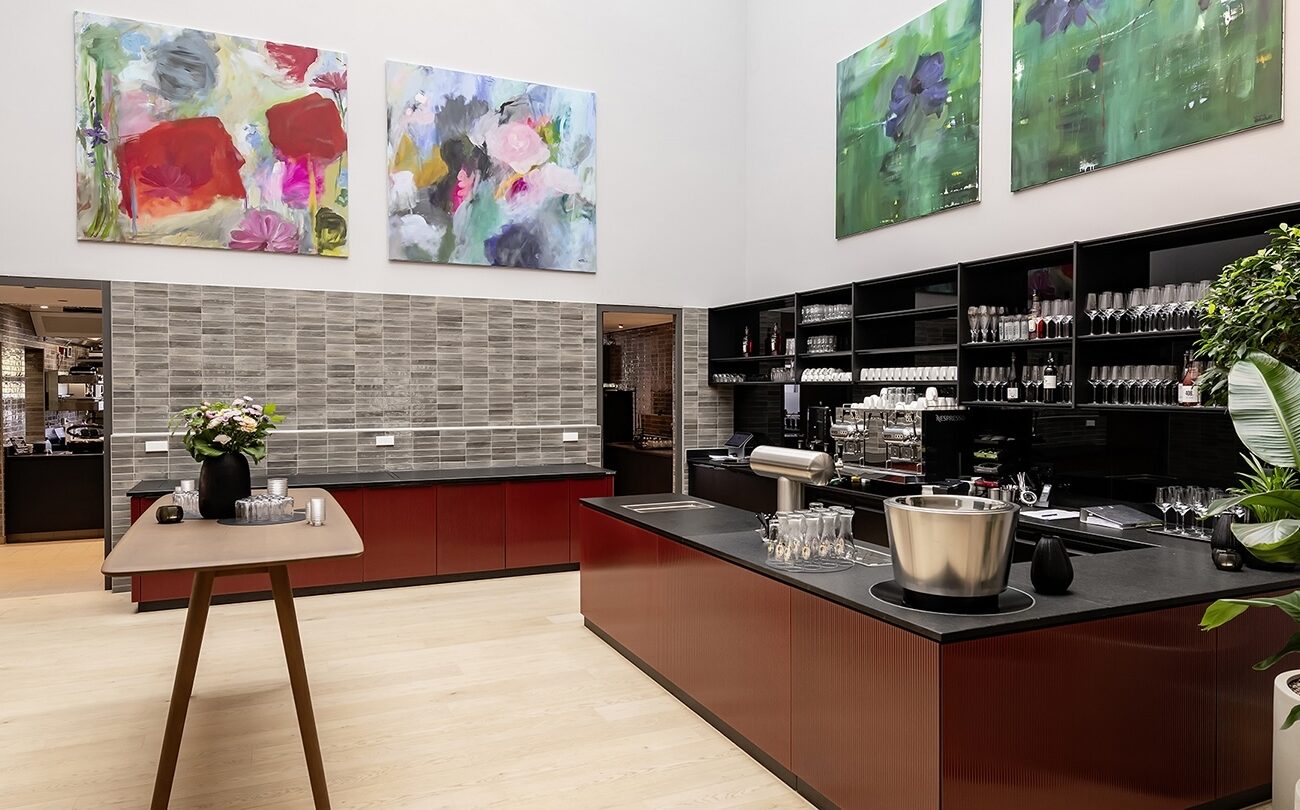 Roter Tresen bestückt mit Gläsern in modernem kunstvoll dekoriertem Innenraum